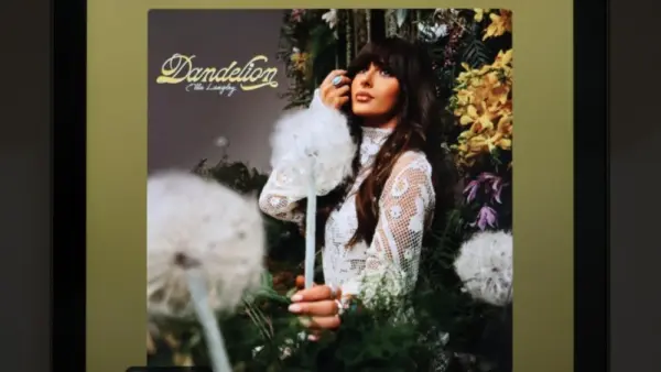The image displays an Apple iPad running the Spotify app^ which shows the song "Be Her" by country artist Ella Langley from her album Dandelion.