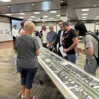 Residents and officials look over East Main Street project maps at an open house at the Galesburg Public Library