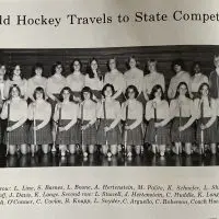 Black and white team photo of the Galesburg High School field hockey team holding sticks^ from a 1970s GHS yearbook page titled "Field Hockey Travels to State Competition"