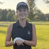 Ella Herchenroder poses with her golf club and ball on the course