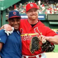 Sammy Sosa and Mark McGwire pose together in their team uniforms in 1998
