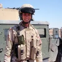 Kyle Wehrly in uniform beside a Humvee in Iraq