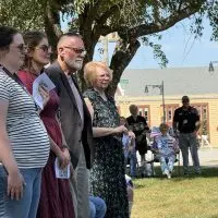 Kyle Wehrly's daughter^ wife^ father and mother standing together during the dedication ceremony