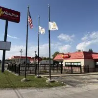 Exterior of the Hardee's restaurant on East Main Street in Galesburg^ with its roadside sign^ flagpoles and an empty parking lot.