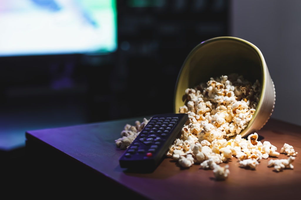 popcorn-and-remote-control-on-table-in-room