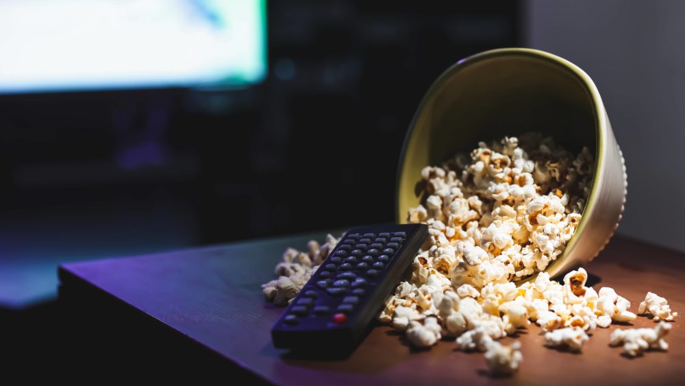 popcorn-and-remote-control-on-table-in-room