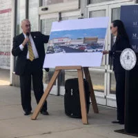 Macomb Mayor Mike Inman and Kim Pierce^ executive Director of the Macomb Area Economic Development Corporation^ unveil two new retailers that will open in the former Kmart in Macomb.