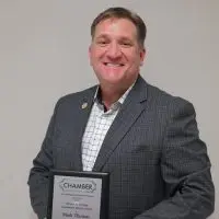Mark Thomas holds the 2025 Thomas B. Herring Community Service Award plaque after being honored by the Galesburg Area Chamber of Commerce.