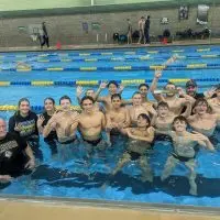 Galesburg High School boys swimming and diving team celebrates fourth straight Western Big 6 Conference championship Saturday at Sterling High School.