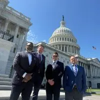 The KCAP Washington delegation — C. Andrew McGadney^ Aaron Gavin^ Adam Vitale^ and Ken Springer — outside the U.S. Capitol in April 2026.