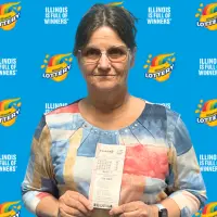 Diana of Carman Illinois holds her winning Powerball ticket after claiming a $1 million prize