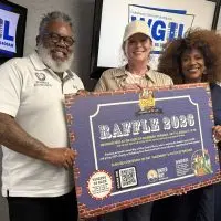 Anthony Law^ Jeannie Weber and Pippi Ardennia holding a Taste of Galesburg raffle poster