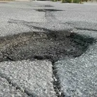 Cracked and crumbling pavement in a Galesburg parking lot