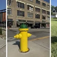 Three Galesburg fire hydrants side by side^ showing orange^ green^ and red color-coded tops.