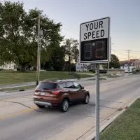 A speed feedback sign showing a vehicle's speed above a posted 30 mph speed limit sign in Galesburg