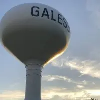 Galesburg water tower against a sunset sky