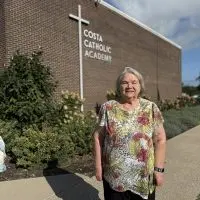 Mary Norton standing outside Costa Catholic Academy in Galesburg^ Illinois
