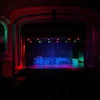 Colored LED stage lights glow red^ green and blue above the stage of the ornate Orpheum Theatre