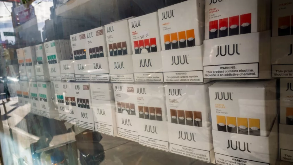 Selection of the popular Juul brand vaping supplies on display in the window of a vaping store in New York