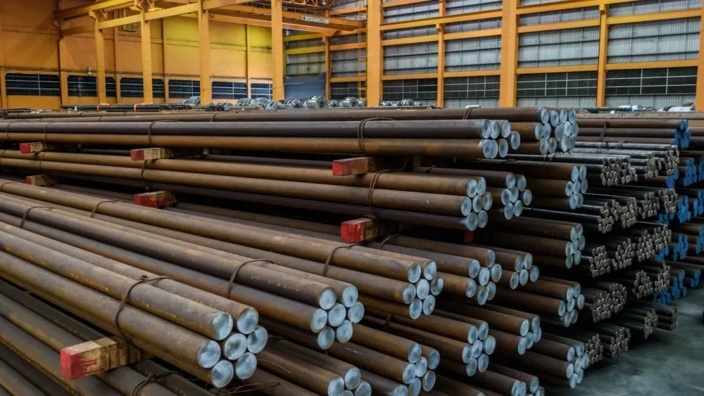 Rows of Steel Round Bar storage and stacking in the warehouse for industrial construction.