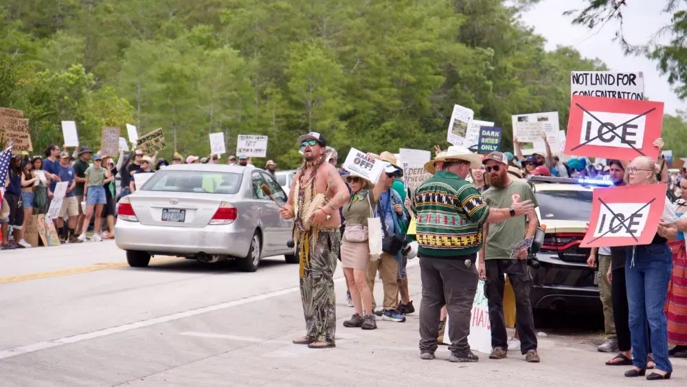 Florida Everglades June 28^ 2025 Protesters line the highway in the Florida Everglades to oppose the construction of "Alligator Alcatraz"^ a new immigrant detention center.