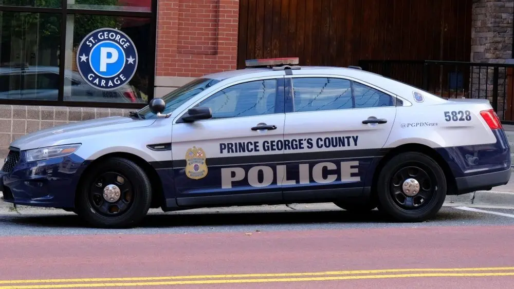 Prince George's County^ Maryland police car sits parked on a street in National Harbor in front of a public parking garage.