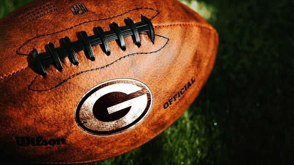 Green Bay Packers or Georgia Bulldogs NFL football Team Logo on the leather of American Football Ball