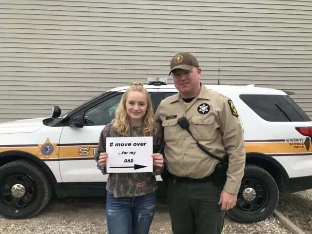 Lucy Kuelper stands next to her father, an Illinois State Over, to encourage drivers to #MoveOver in 2019. (File Photo/Submitted)