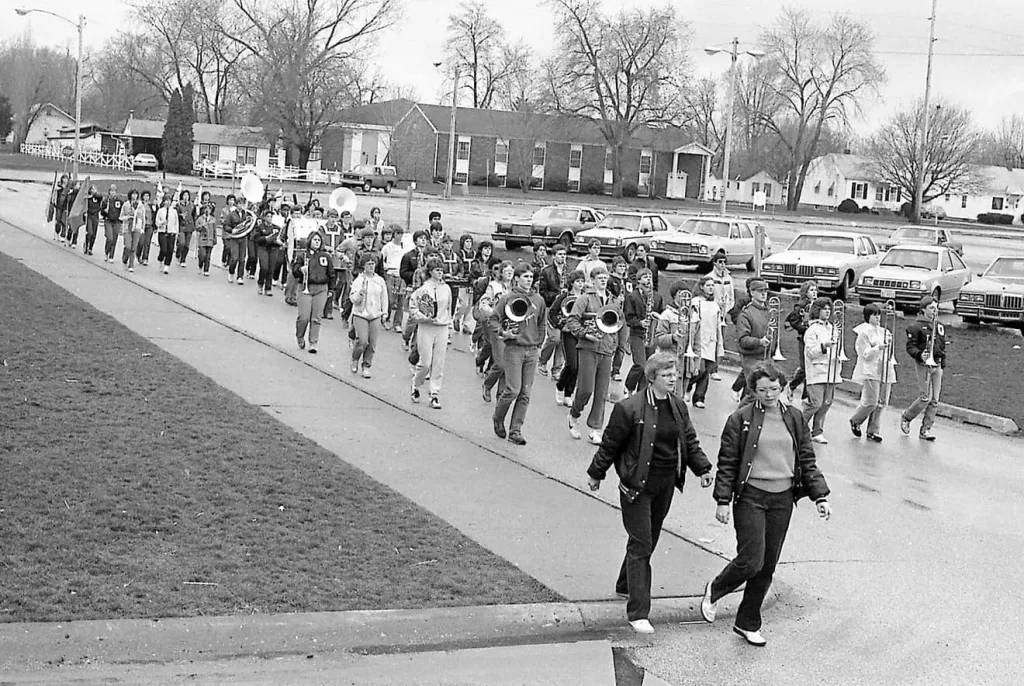 Former GHS Band Director Sally Rynott, front left, and Cindy Leonard walk ahead of the band along the sidewalk on Silver Streaks Drive.