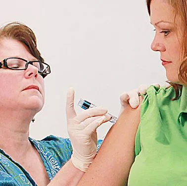17095-a-nurse-giving-a-woman-a-flu-vaccine-shot-pv-e1522258411119