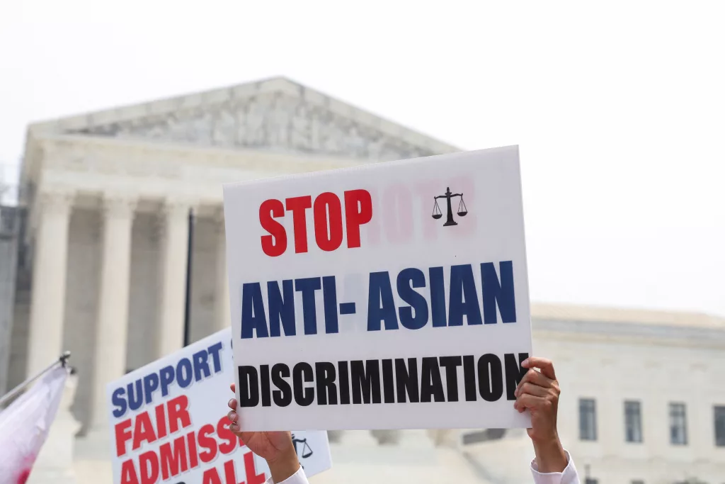 Protesters hold signs as demonstrators for and against the U.S. Supreme Court