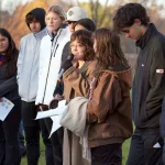 Nayana Foshay and Azaria Foshay and members of the Sandburg Hispanic-Latino Student Association address the crowd at a plaque dedication ceremony  marking the location of four Railroad Camps on Monday, Oct. 30, 2023, in Galesburg. (BILL GAITHER/CARL SANDBURG COLLEGE)