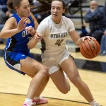 streaks-vs-quincy-gbb-01: Galesburg senior Kiarra Kilgore drives past a Quincy defender during the Silver Streaks' 55-41 WB6 Conference win over the Blue Devils on Thursday, Dec. 7, 2023 at John Thiel Gymnasium.