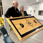 Former Streak Amy Crisman Howell, GHS Class of 1981, poses with Galesburg girls basketball coach Evan Massey during a reception for Massey's 1,000th career win Thursday, Dec, 14, 2023, at GHS.