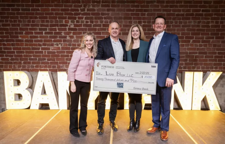Lux Blox LCC of Galesburg was the winner in the Bank Tank pitch contest sponsored by Fortress Bank on Thursday, Feb. 22, 2024, in Davenport, Iowa. Pictured in the center are Lux Blox owners Mike and Heather Acerra.