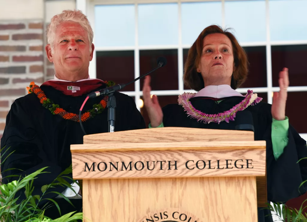 Actress Sigourney Weaver and her writer/director husband, Jim Simpson deliver the commencement address Sunday, May 19, at Monmouth College's 2024 graduation, held on the College's Wallace Hall Plaza. They were both presented with a doctor of humane letters by the College.