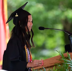Monmouth College senior Lillian Hucke of Aledo, Illinois, delivers the student address on Sunday, May 19, during the College's 2024 commencement ceremony, held on the Wallace Hall Plaza. Hucke was the College's Student Laureate of the Lincoln Academy of Illinois.