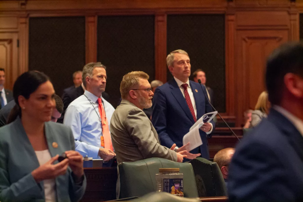 Rep. Patrick Windhorst, R-Metropolis, reads the House rules as members of his party look on. His procedural maneuvering forced Democratic leadership to suspend the rules in order to get enough members in the chamber to pass the revenue plan. (Capitol News Illinois photo by Jerry Nowicki)