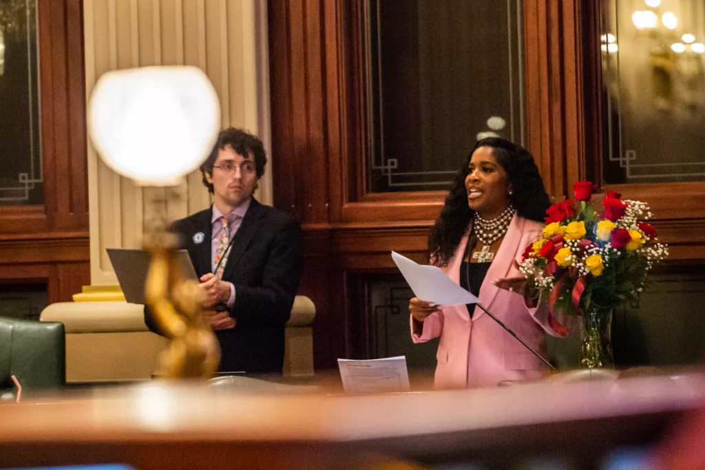 Brady Burden, a member of House Speaker Emanuel “Chris” Welch’s staff, accompanies Rep. Jehan Gordon-Booth, D-Peoria, during floor debate of the budget bill early Wednesday morning. Burden and the Illinois Legislative Staff Association, which is a group of House employees that are seeking to unionize, filed suit against Welch Friday. (Capitol News Illinois photo by Jerry Nowicki)