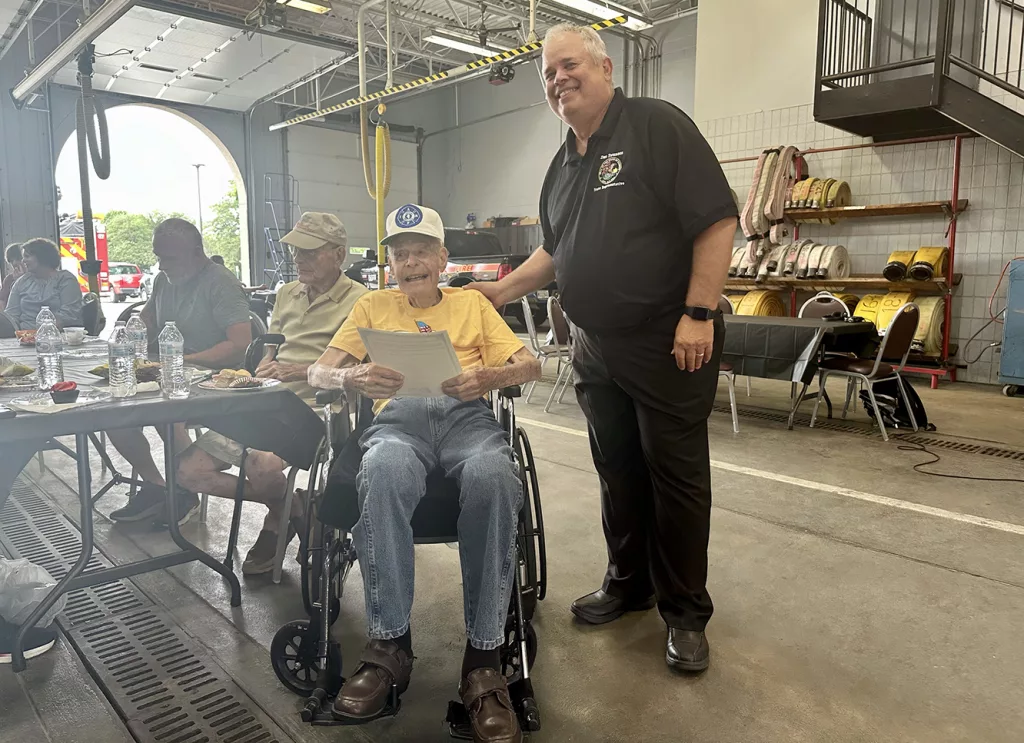 State Representative Dan Swanson presents a proclamation to former Galesburg Firefighter Bob Redfern for his service and upcoming 100th birthday at a celebration Tuesday at Galesburg Central Fire Station.