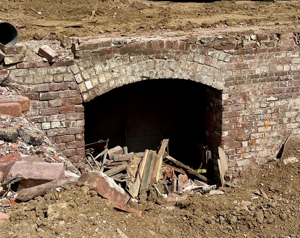 As cleanup continues at the demolition site of a downtown Galesburg building at Main and Prairie streets, interesting finds and artifacts emerge. One appears to be an underground tunnel or entrance way under the sidewalk in the first block of North Prairie Street.