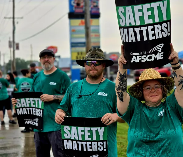 From right to left, Falynne Muzzy, a correctional lieutenant, and Hursel King, a correctional sergeant, both employed at Menard Correctional Center, and Michael Knope, a correctional sergeant at Pinckneyville Correctional Center, joined hundreds of other prison workers and their supporters in Chester on Monday to rally against unsafe working conditions. (Capitol News Illinois photo by Molly Parker)