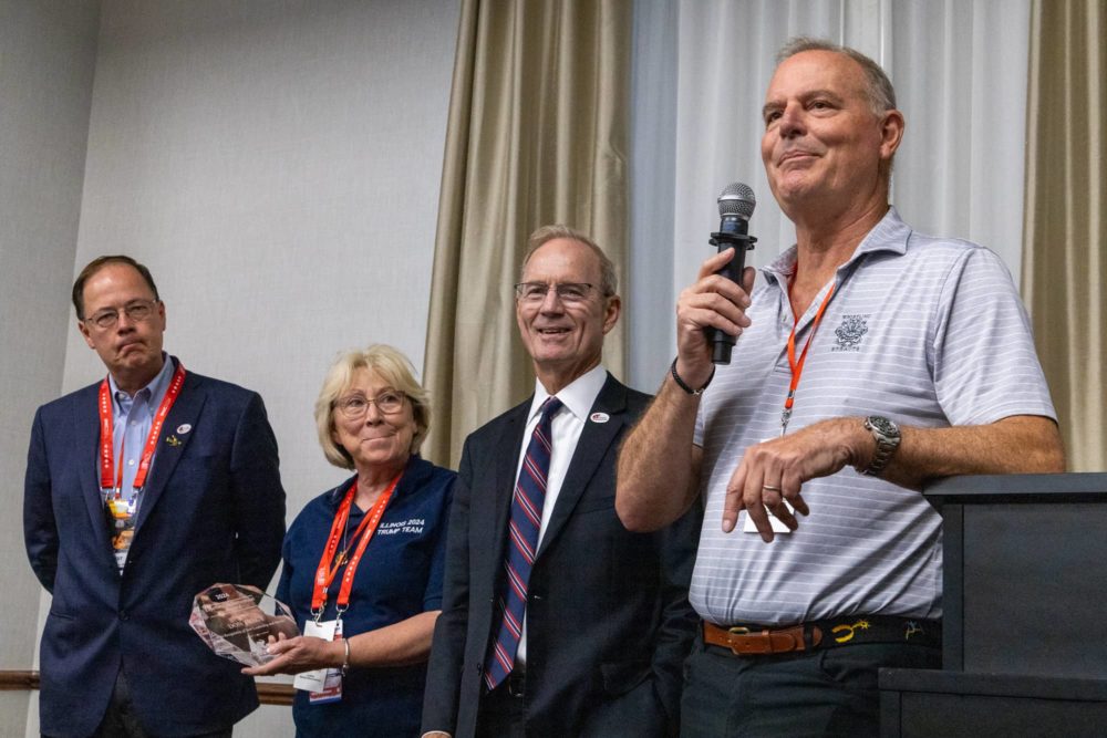 Illinois’ outgoing Republican National Committeeman Richard Porter speaks to the state’s delegation to the Republican National Convention in Milwaukee on Thursday. He’s joined by (left to right) Dean White and Rhonda Belford who will be the state’s new national committee representatives. To Porter’s left is outgoing GOP Chair Don Tracy. (Capitol News Illinois photo by Andrew Adams)