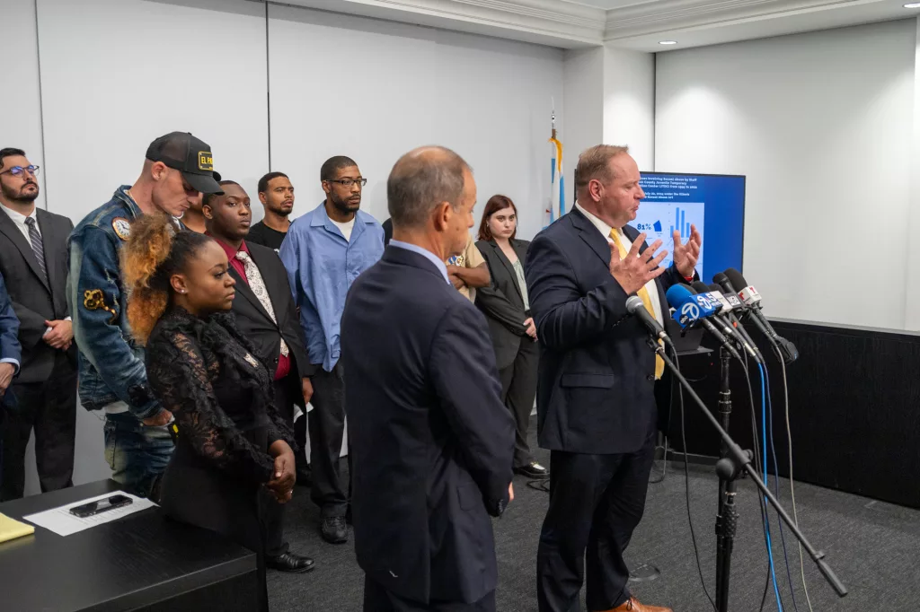 Attorney Todd Mathews speaks to reporters at a news conference announcing a set of lawsuits alleging decades of abuse at a Cook County youth detention facility. He stands in front of survivors of the alleged abuse as well as other attorneys working on the case. (Capitol News Illinois photo by Andrew Adams)
