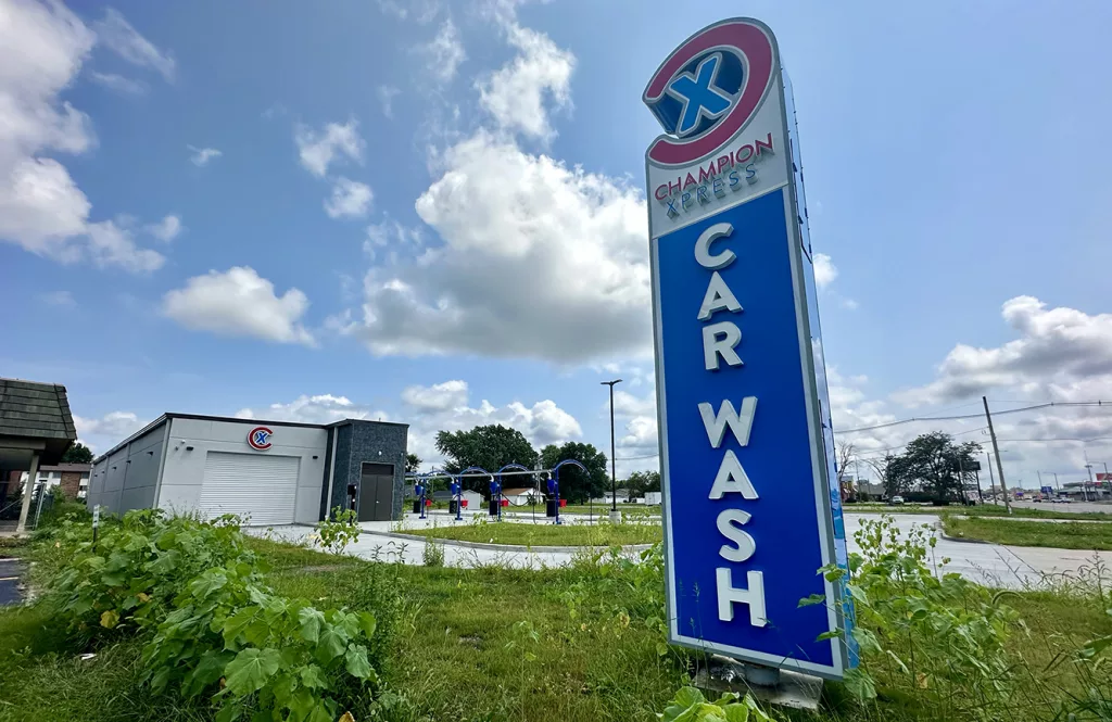 A new Champion Xpress car wash at 1819 N. Henderson St. is now scheduled to open in “mid September.”