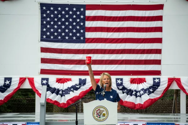 Illinois House Republican Leader Tony McCombie toasts to the audience at Republican Day at the Illinois State Fair. She thanked a GOP donor “not only for the cup, but for what's in it.” (Capitol News Illinois photo by Jerry Nowicki)