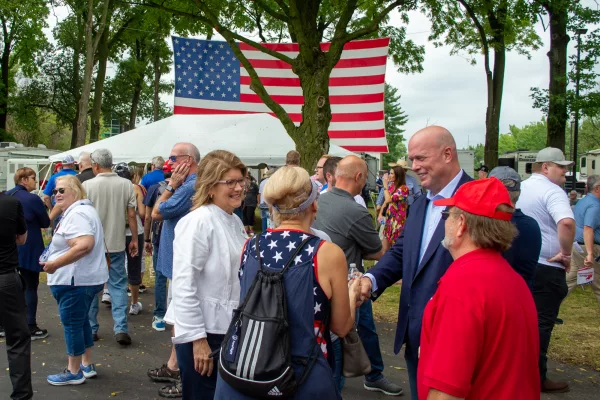 Illinois Republican Party Chair Kathy Salvi (left), and Republican Day guest speaker Matthew Whitaker (right), who served under former President Donald Trump as acting attorney general, greet rally attendees at the Illinois State Fair on Thursday. (Capitol News Illinois photo by Jerry Nowicki)