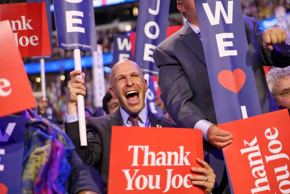  State Rep. Bob Morgan celebrates with members of the Illinois delegation on Monday night, the first night of the Democratic National Convention. (Capitol News Illinois photo by Andrew Adams) 