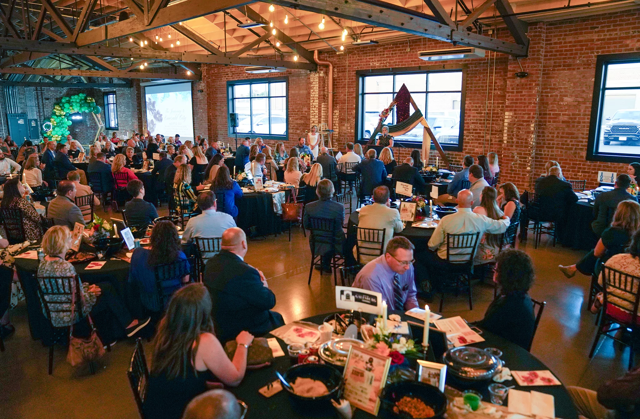 Pam Gaither, executive director of the Galesburg Area Chamber of Commerce, speaks from the podium during the Annual Dinner & Excellence Awards on Thursday, Aug. 22, 2024, at The Vault.