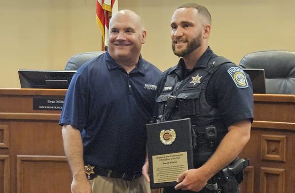 Galesburg Police Department Officer Jake Taylor, right, receives the 2023 Galesburg Area Crime Stoppers Officer of the Year award from GPD Chief Russ Idle.